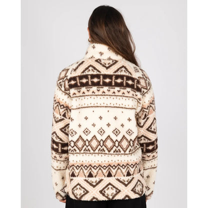 Back view of a woman wearing a Saltrock 1/4 zip Skylar fleece in cream with a brown geometric pattern