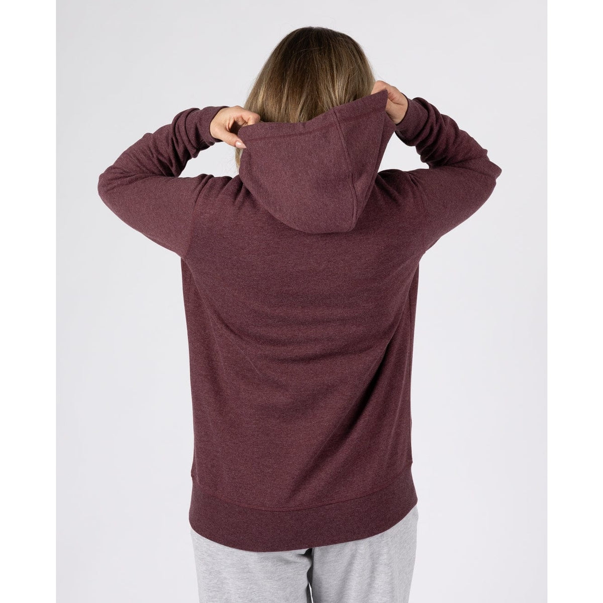 Back view of a woman wearing a Saltrock Velator hoodie in Dark Purple.