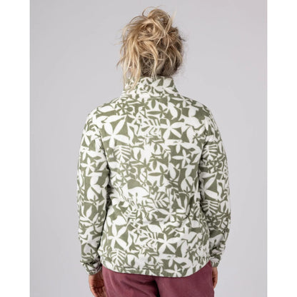 Back view of a woman wearing a Saltrock green floral patterned Balance fleece on a grey background