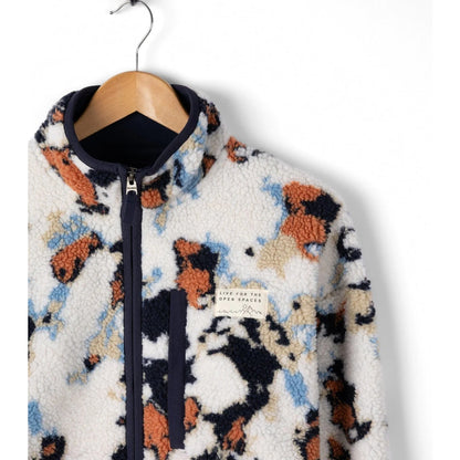 Fluffy patterned Saltrock Folie fleece on a hanger against a white background