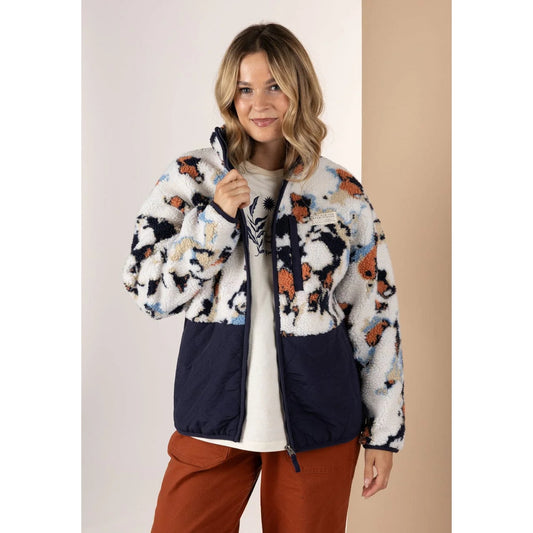 Woman wearing a patterned Saltrock Folie fleece with a white background