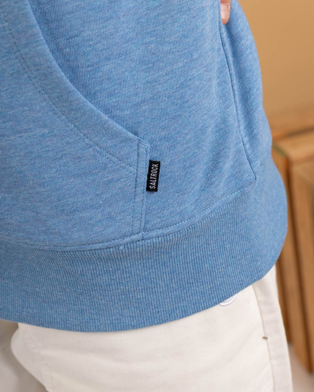 Close-up of Saltrock womens blue lined hoodie pocket and branded tag on soft fabric