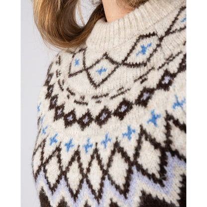 Close-up view of the cream, brown and blue pattern across the chest of a womens Saltrock Fern jumper.