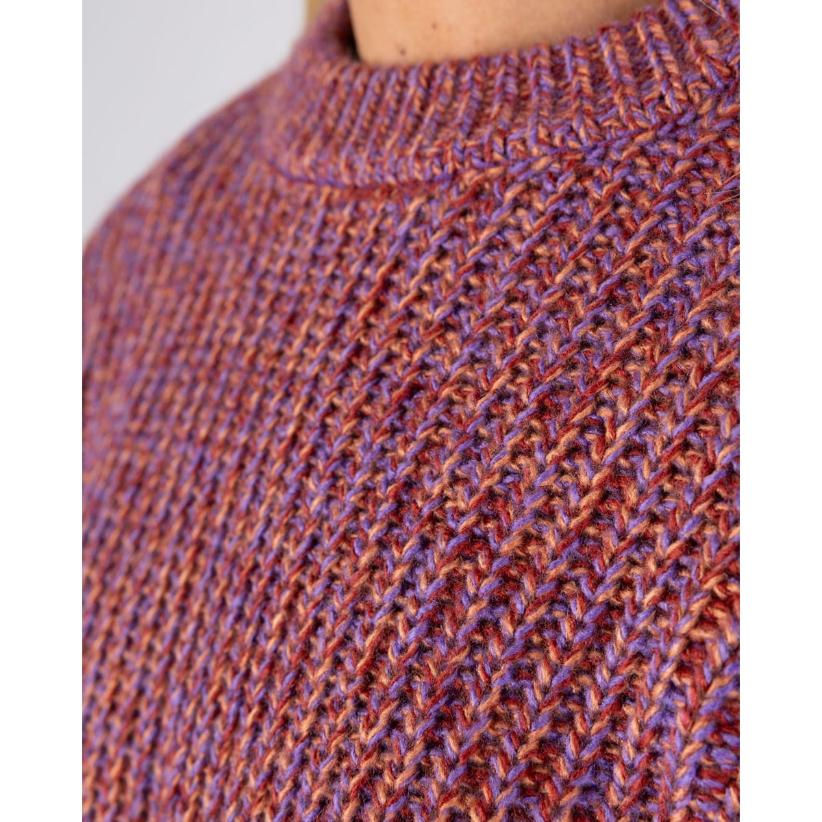 Close-up view of the neckline on a womens Saltrock Lucy crew neck longline knitted jumper in purple.