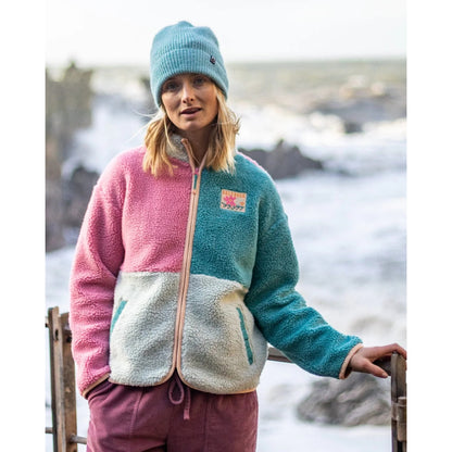 Front view of a woman wearing a colourful Saltrock Emery Wave fleece jacket in pink, teal and turquoise
