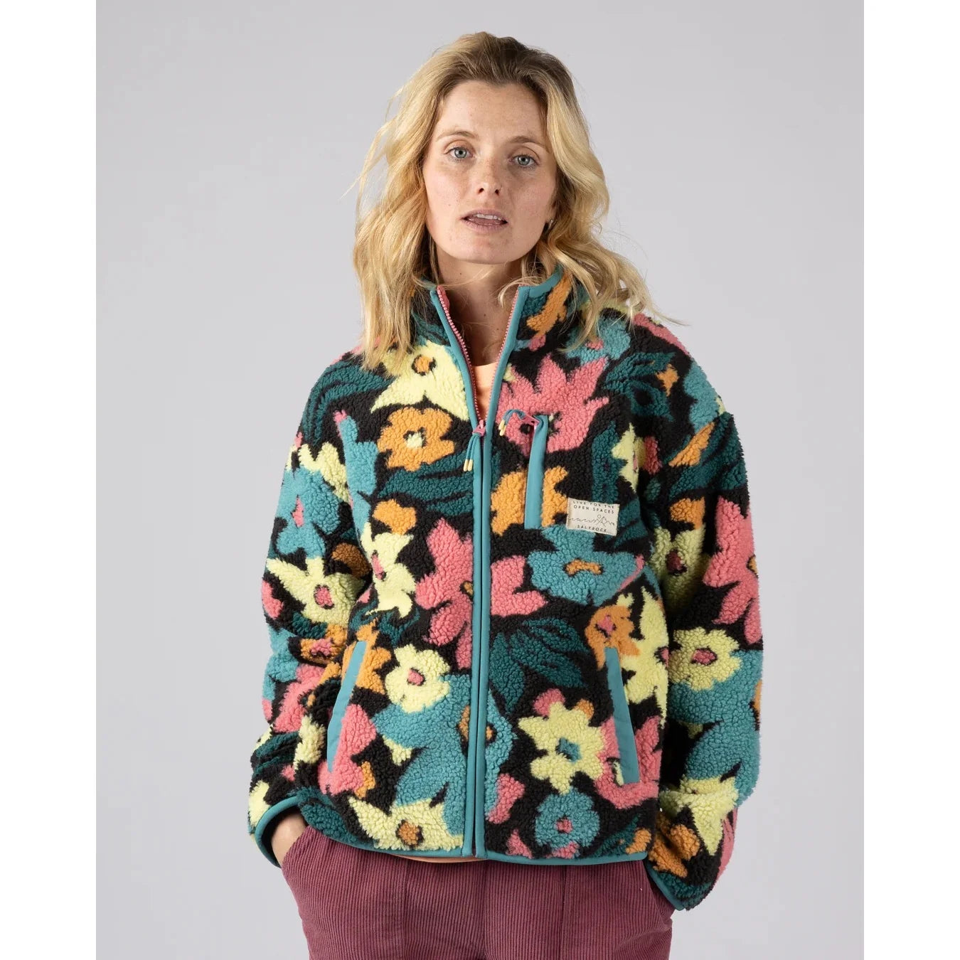 Front view of a woman wearing a Saltrock Holidaze multicolour floral sherpa zip fleece