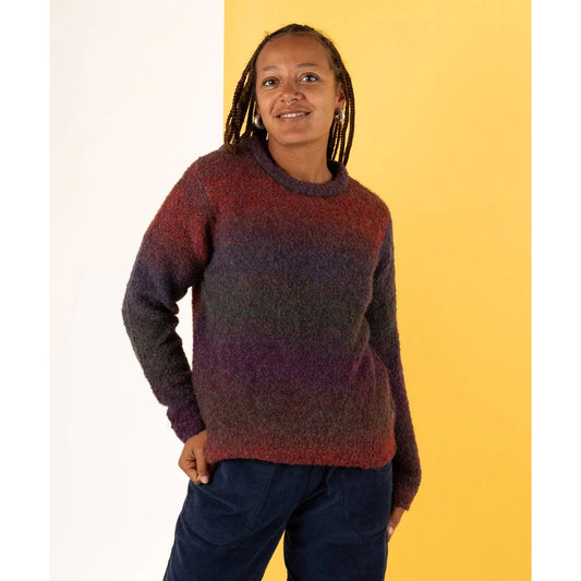 Front view of a woman wearing a Saltrock Bowden knitted crew neck jumper in Dark Purple on a yellow background.