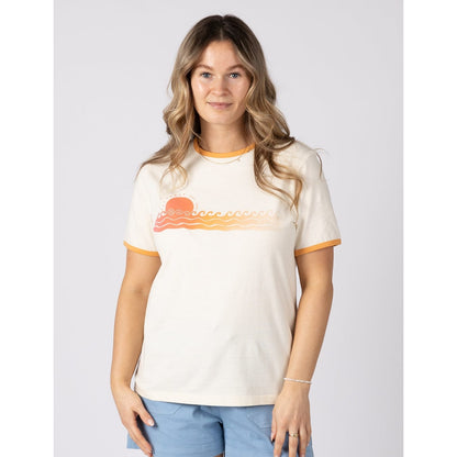 Front view of a woman wearing a short sleeve Saltrock Gold Hour ringer t-shirt in cream with blue shorts on a plain background