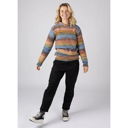 Woman wearing a multicolour striped Saltrock Space Dye Erin knitted hoodie and black pants
