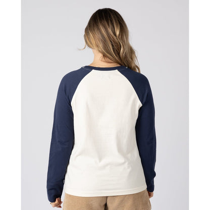 Back view of a woman wearing a Saltrock long sleeve Golden Hour t-shirt in cream with navy blue raglan sleeves