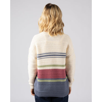 Back view of a woman wearing a cream  Saltrock knitted jumper with a colourful striped pattern