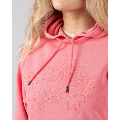 Close-up vie of a Saltrock womens Trader Tonal bright pink pop hoodie with embroidered chest logo on a plain background