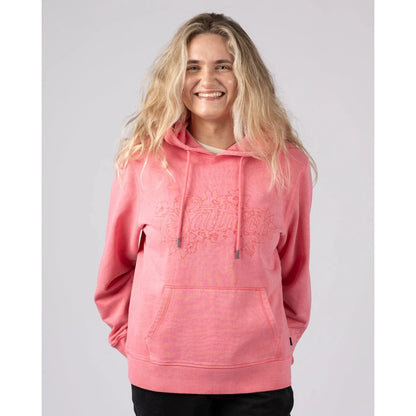 Front view of a woman wearing a bright pink Saltrock Trader Tonal pop hoodie with a white background