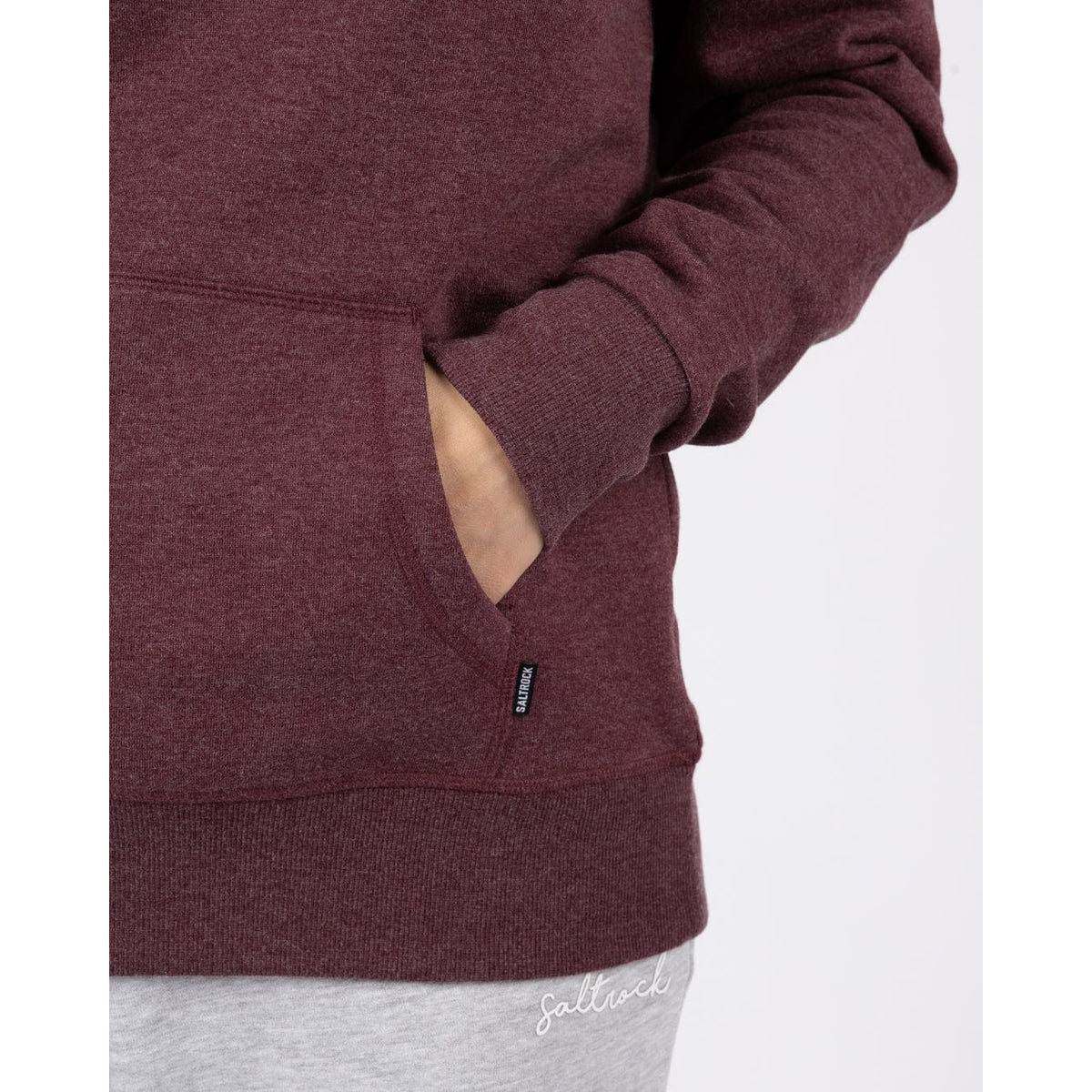 Close-up view of the tummy pocket of a womens Saltrock Velator hoodie in Dark Purple.