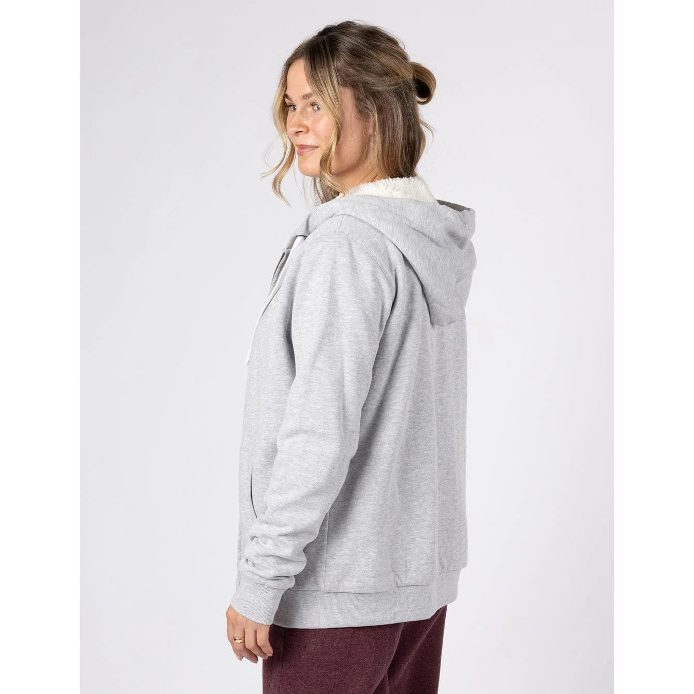 Back view of a woman wearing a Saltrock Velator full zip borg lined grey hoodie on a white background