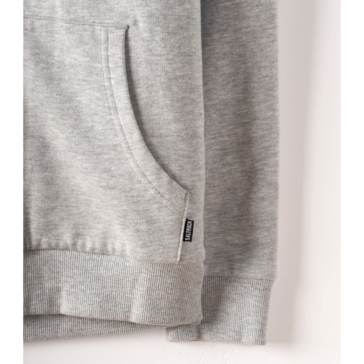 Close-up of a Saltrock womens Velator borg lined hoodie in grey with a brand label on a white background