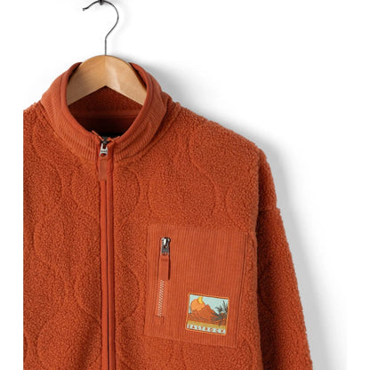 Orange fleece jacket with a patch on a hanger against a white background