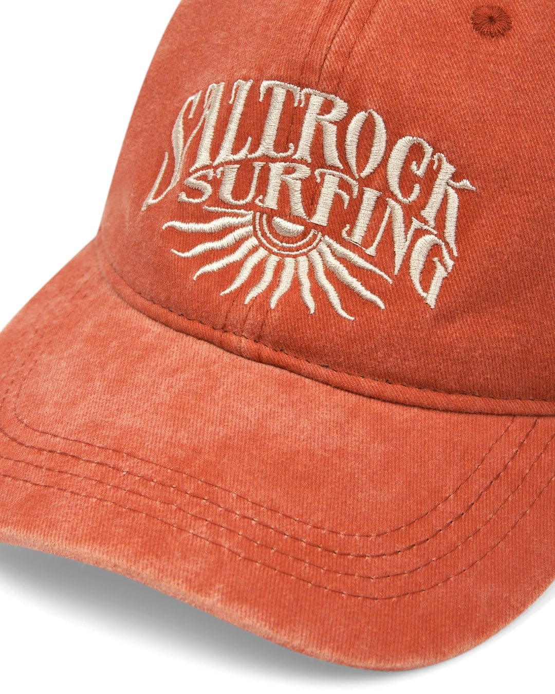 Adults Sunburst cap from Saltrock in washed look Burnt Orange with embroidered sunburst logo.