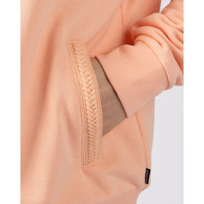Close-up of a Saltrock peach or light pink coloured Tamsin hoodie with braided pocket detail on a white background