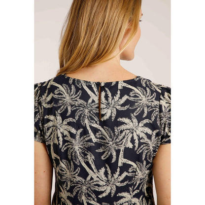 Close-up view of the back of a woman wearing a Weird Fish short sleeve Breeza tunic in Midnight Navy with a beige palm tree pattern.