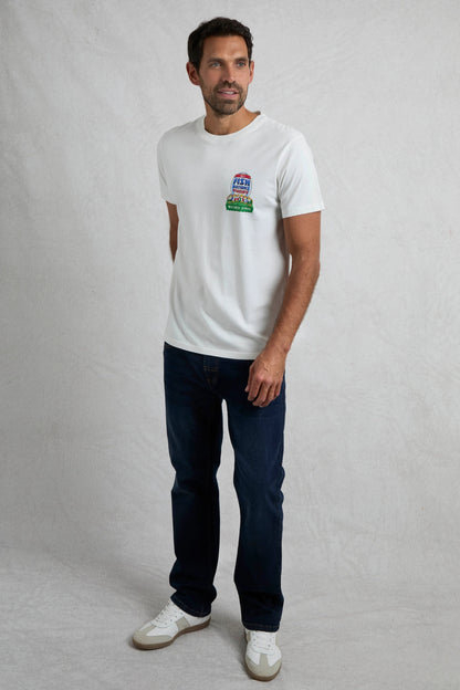 Man wearing a Weird Fish short sleeve white t-shirt with a rugby themed print, with jeans on a white background