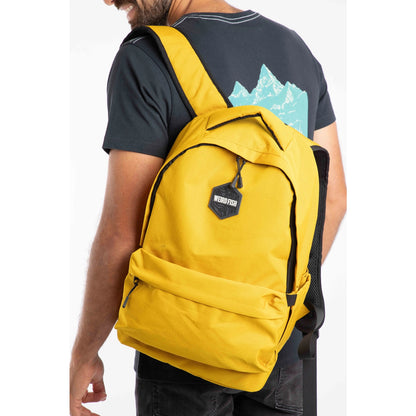 Main view of a person wearing a yellow Weird Fish Nevis backpack with a visible brand logo on a white background