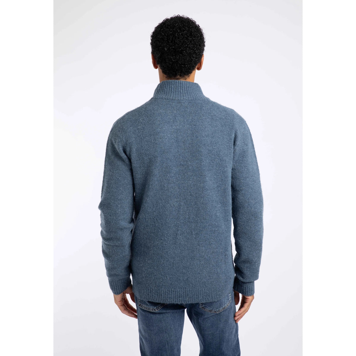 Back view of a man wearing a Weird Fish 1/4 zip Altwood knitted jumper in Ash Blue.