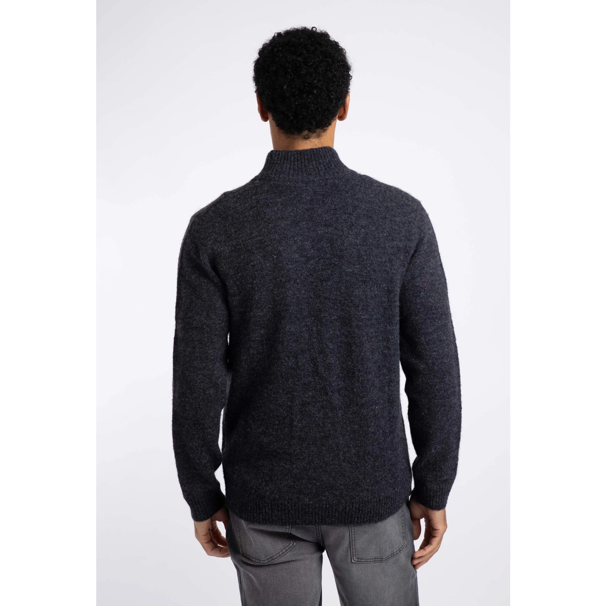 Back view of a man wearing a Weird Fish 1/4 zip Altwood knitted jumper in Midnight Navy.