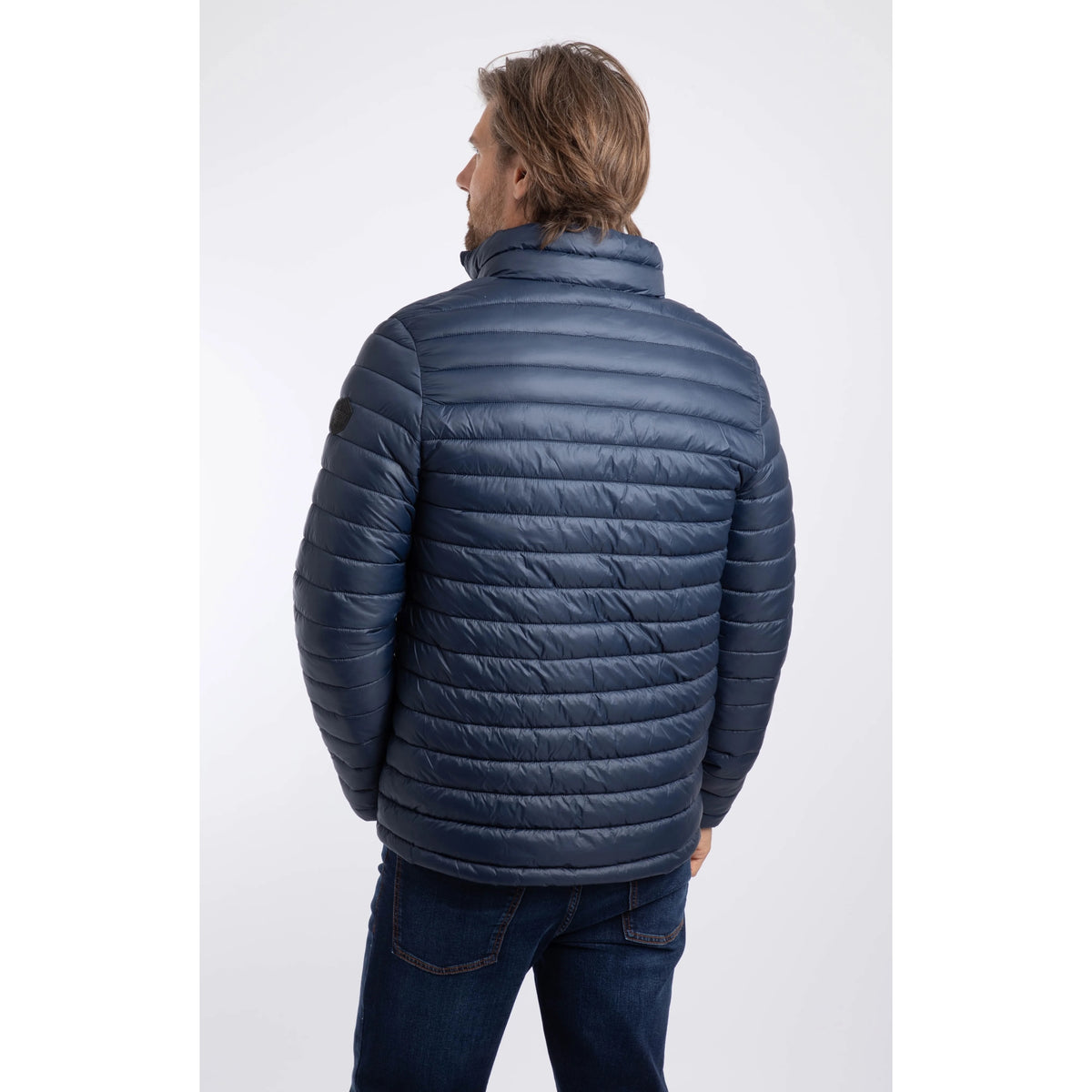 Back view of a man wearing a Weird Fish Crantock padded jacket in navy.