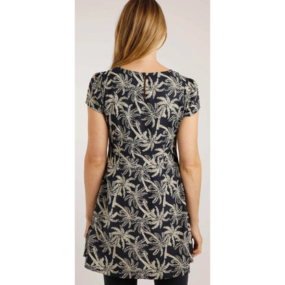 Back view of a woman wearing a Weird Fish short sleeve Breeza tunic in Midnight Navy with a beige palm tree pattern.