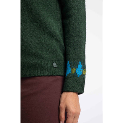 Close-up view of the sleeve cuff and small metal logo fob of a Weird Fish knitted Lowell jumper in Bottle Green, with a Fair Isle pattern across the chest and shoulders.