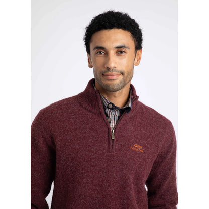 Close-up view of a man wearing a Weird Fish 1/4 zip Altwood knitted jumper in Garnet Red