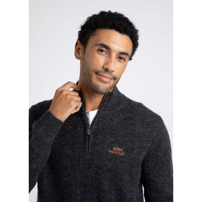 Close-up view of a man wearing a Weird Fish 1/4 zip Altwood knitted jumper in Midnight Navy.