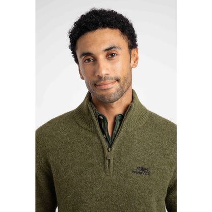 Close-up view of a man wearing a Weird Fish 1/4 zip Altwood knitted jumper in Winter Green.