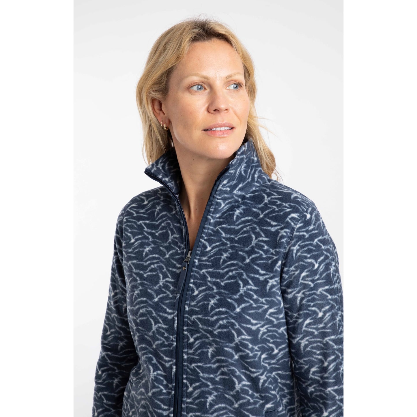 Close-up view of a woman wearing a Weird Fish full zip Rochelle microfleece in Night Blue with a gull bird print.