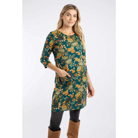 Woman wearing a Weird Fish Deep Teal Starshine dress with a multicolour floral pattern on a white background
