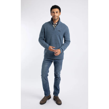 Front view of a man wearing a Weird Fish 1/4 zip Altwood knitted jumper in Ash Blue with blue jeans and brown boots.