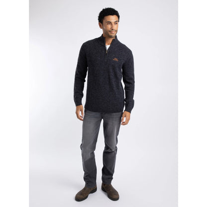 Front view of a man wearing a Weird Fish 1/4 zip Altwood knitted jumper in Midnight Navy with blue jeans and brown boots.