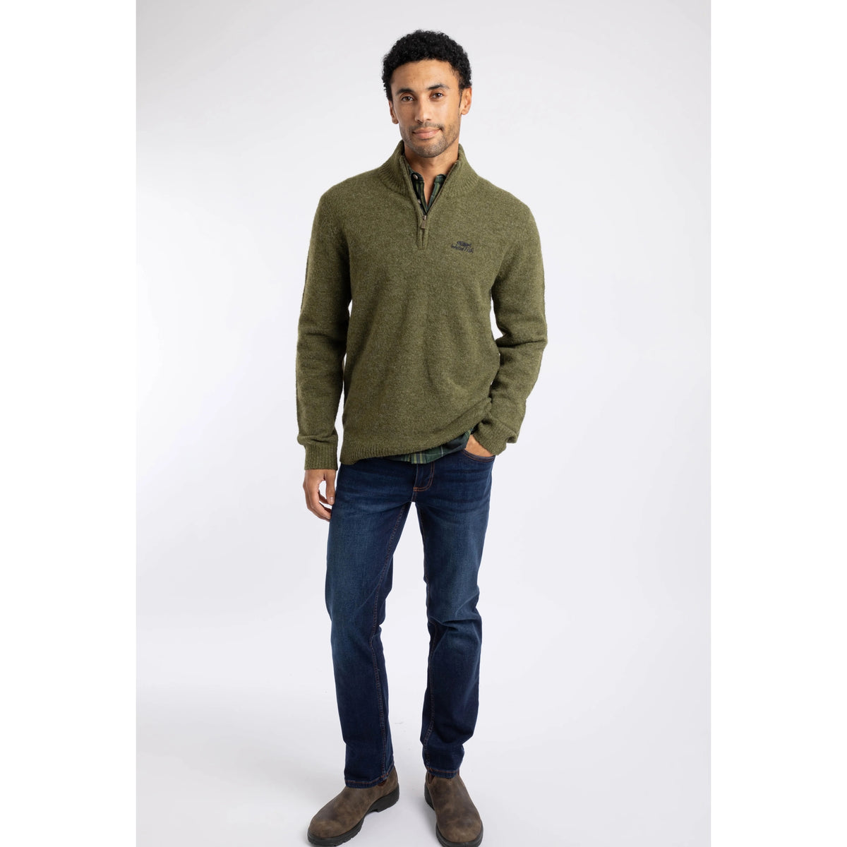 Front view of a man wearing a Weird Fish 1/4 zip Altwood knitted jumper in Winter Green with blue jeans and brown boots.