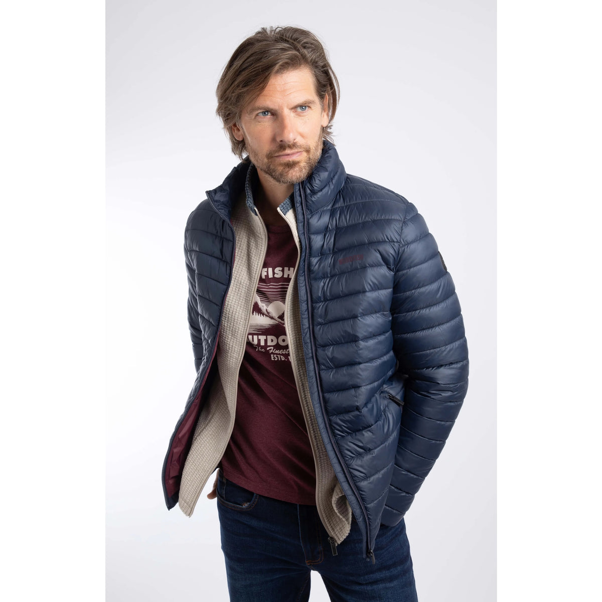 Front view of a man wearing a Weird Fish Crantock padded jacket in navy unzipped.