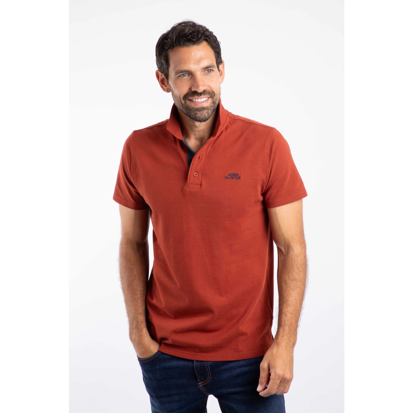 Front view of a man wearing a short sleeve Weird Fish Miles polo shirt in Burnt Henna.