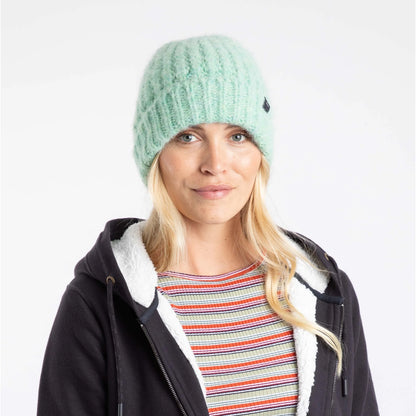 Woman wearing a Weird Fish light green Clare knitted beanie and black jacket with white lining on a white background