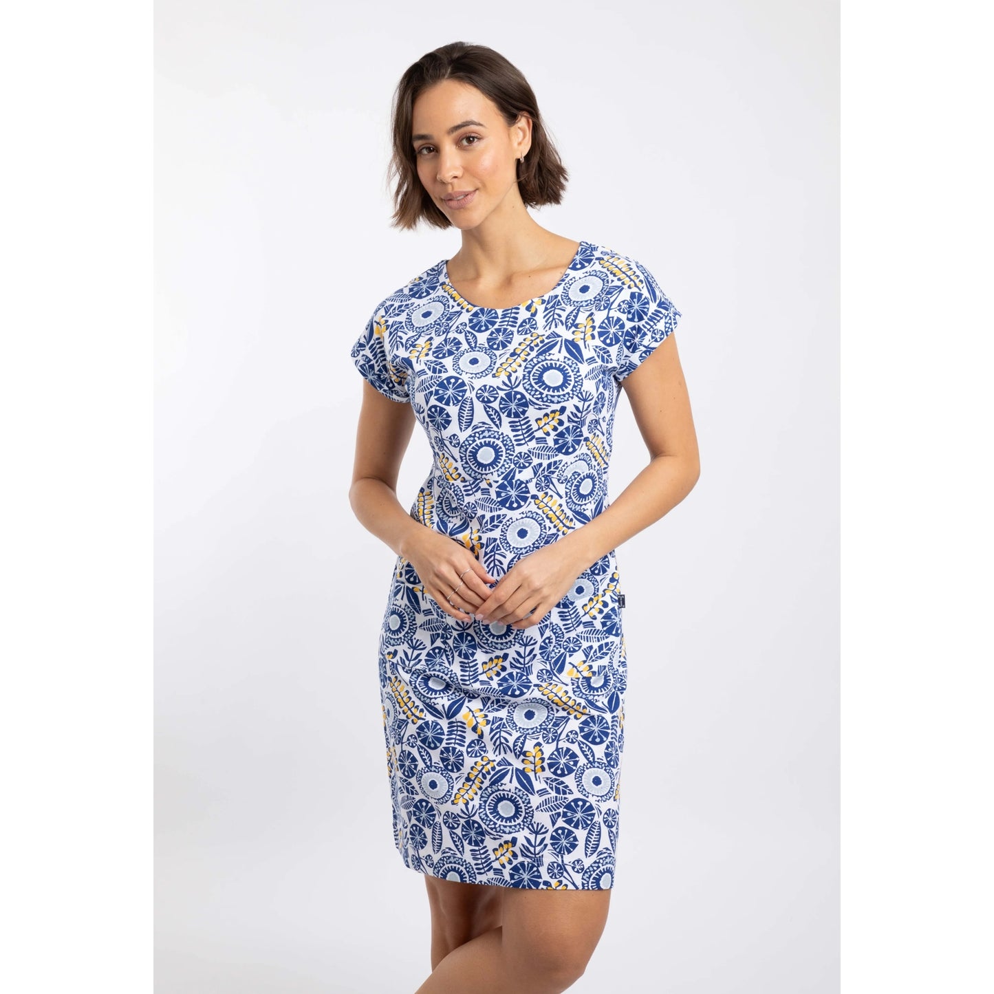 Front view of a woman wearing a Weird Fish short sleeve Tallahassee dress in Sapphire Blue featuring an abstract floral print and front pockets.