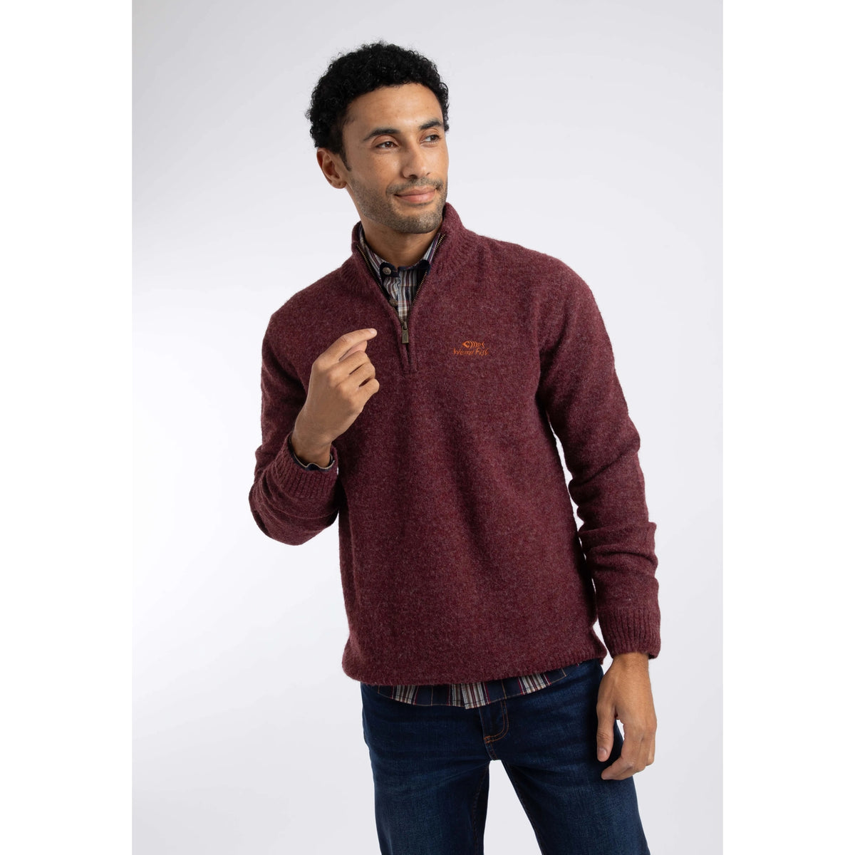 Front view of a man wearing a Weird Fish 1/4 zip Altwood knitted jumper in Garnet Red.