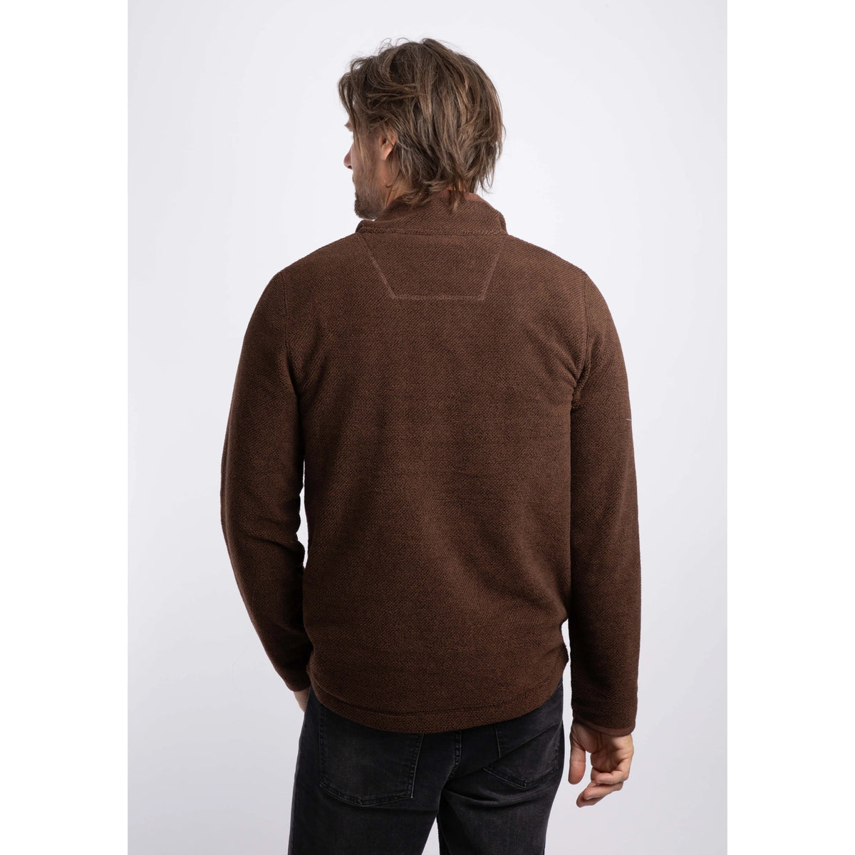 Back view of a man wearing a Weird Fish quarter zip textured Errill fleece in Chocolate brown.