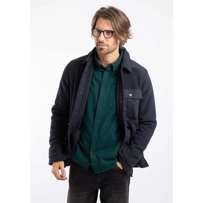 Man wearing a Weird Fish mens Boyd fleece jacket over a green shirt on a white background