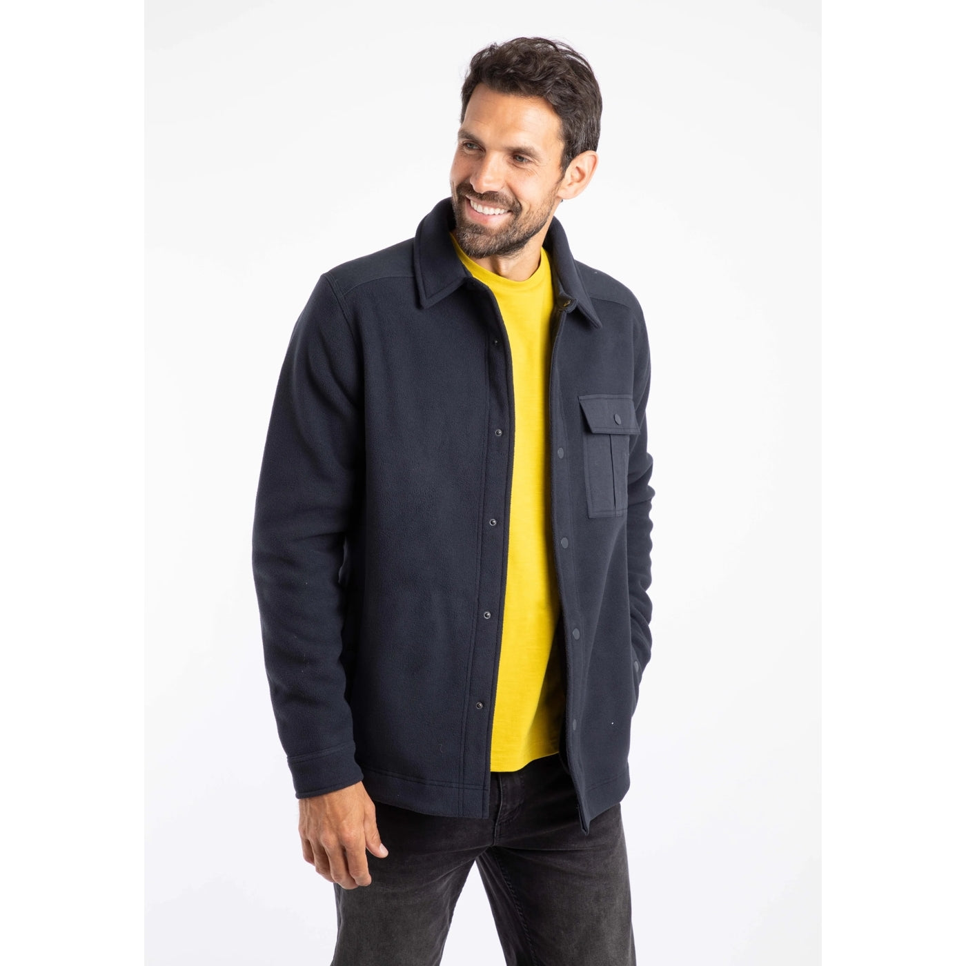 Man wearing a Weird Fish navy Boyd fleece jacket over a yellow shirt on a white background