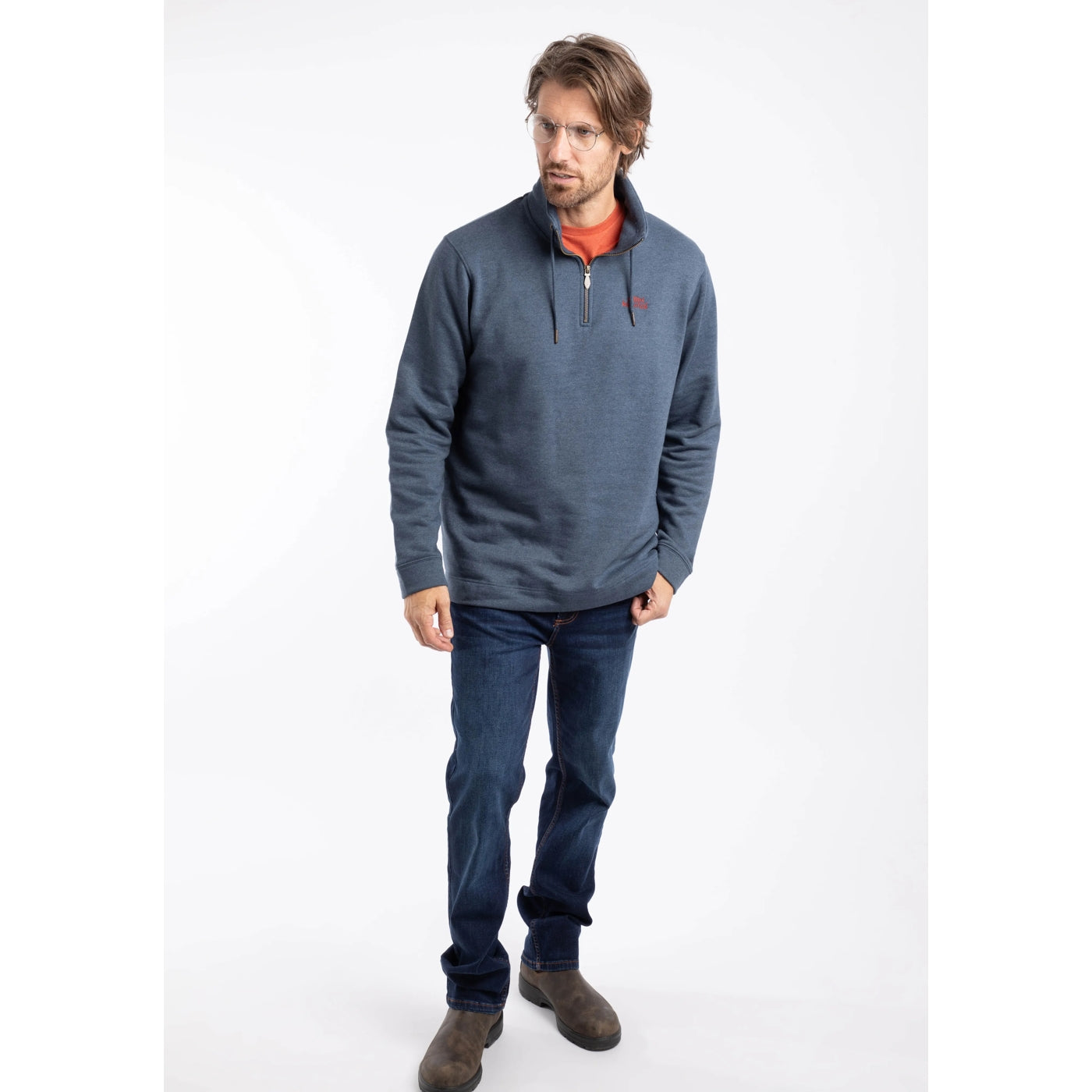 Man wearing a Weird Fish navy blue Brampton sweatshirt with a logo on a white background