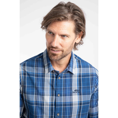 Close-up view of a man wearing a Weird Fish long sleeve Lando shirt in a blue, navy and white check pattern.