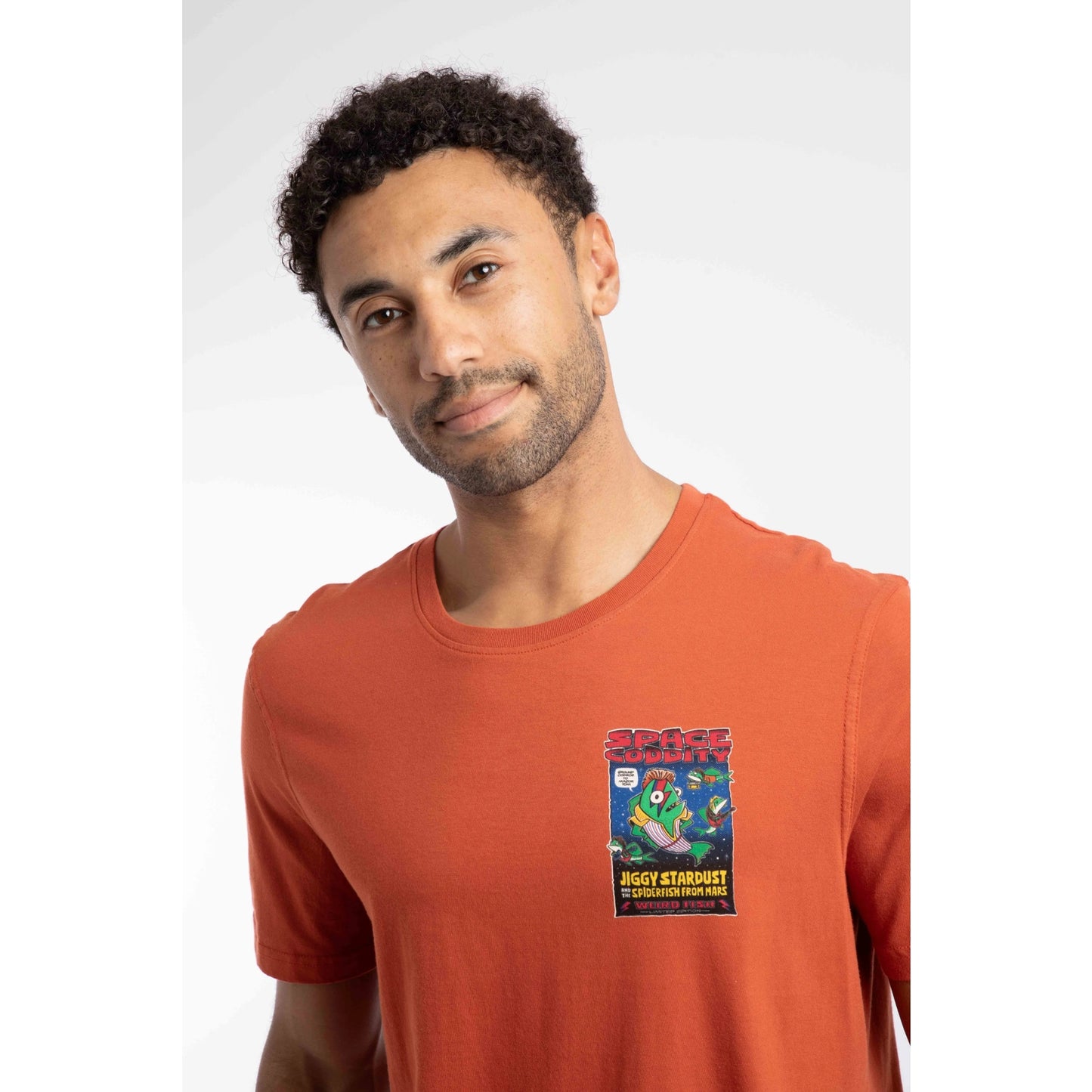 Close-up view of a Weird Fish men's Space Coddity printed t-shirt in a Rust Leaves shade of orange.